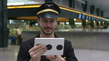 Airline pilot captain working at airport terminal in a uniform video