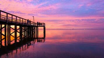 Pier at sunset on Mobile bay photo