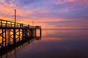 Pier at sunset on Mobile bay photo