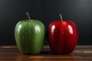 Red and green apples with water drops on wooden table against black background photo
