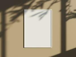 Minimal picture poster frame mockup on the wall with window shadow and leaves photo