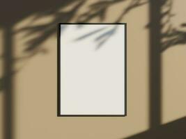 Minimal picture poster frame mockup on the wall with window shadow and leaves photo