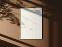 Minimal picture poster frame mockup on the wall with window shadow and leaves photo