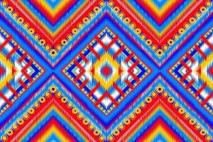 Seamless design drawn tribal chevron pattern with african Aztec ethnic and tribal ornament. Vector dark and bright pink blue yellow color boho fashion illustration. Design for textile, carpet, rug