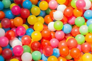 A vibrant background array of balloons illuminates the image with a carnival-like atmosphere varied in color, float above the pool photo