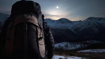 Tourist back with a backpack, background of snow-capped mountain peaks. . photo