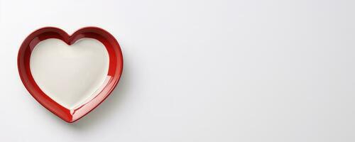 Vivid heart plate isolated on background with a copy space, top view photo