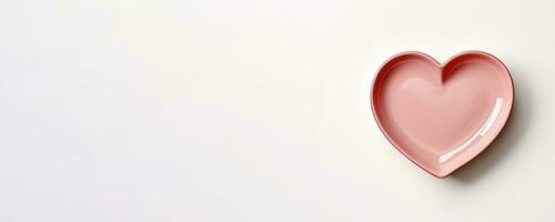 Vivid heart plate isolated on background with a copy space, top view photo