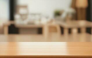 Wooden desk table looking out to a defocussed modern kitchen background photo