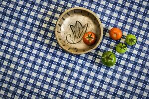 Green and red tomatoes on the table photo