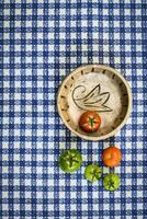 Green and red tomatoes on the table photo