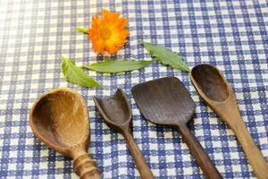 Rustic wooden spoons on the table. photo