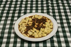 Plate of homemade gnocchi with tomato sauce photo