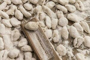 Handmade gnocchi  on the table. photo