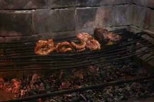 Cow bowels presented on a grill. Argentine Traditional cuisine. photo