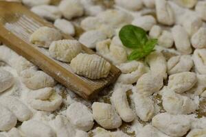 Cook homemade gnocchi on the table, Italian tradition photo