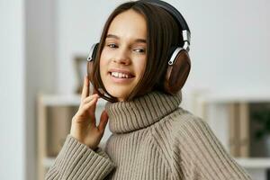 home woman caucasian indoor happy earphones typing young music student headphones photo