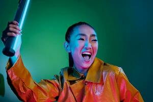 Disco woman trendy purple green light neon yellow colorful fashion brunette night beauty photo