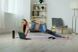 woman training fitness video yoga lifestyle laptop health home mat lotus photo