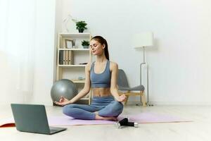 woman laptop lifestyle mat training dumbbells video yoga health home lotus photo