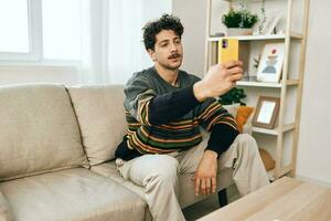 Man person lifestyle selfie sofa technology phone message communication home typing photo