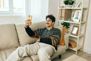 Communication man selfie typing mobile sofa lifestyle phone message home technology photo