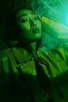 Woman trendy colourful neon portrait night art smoke concept light green beauty photo