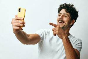 Man phone message t-shirt looking online portrait lifestyle attractive travel technology internet hipster white photo