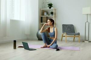 woman lotus home lifestyle health yoga room training video mat laptop photo