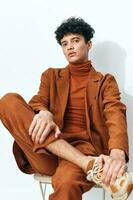 Man portrait fashion sitting beige thoughtful photo