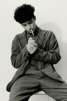 Man student cigarette sitting lifestyle thoughtful hipster and portrait youth black white smoking fashion photo