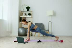 mat woman yoga healthy training laptop health lifestyle video home lotus photo