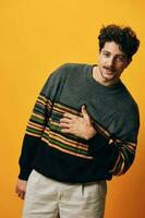 Man smile student cool orange fashion studio portrait background lifestyle sweater trendy happy male winter photo