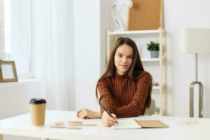 desk table girl notebook exam education schoolgirl student teenager preparation photo