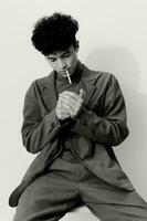 And man thoughtful hipster sitting model portrait smoking posing fashion white cigarette black student photo