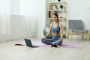 laptop woman video training lifestyle copy yoga lotus space mat health home photo