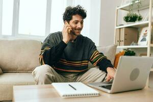 Man computer freelance business smile connection notebook working laptop home online couch photo