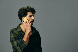 Sad man happy background technology shirt studio lifestyle phone positive grey stylish face smile caucasian photo