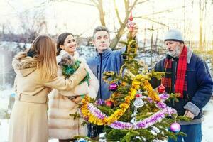 Family decorating Christmas Tree photo