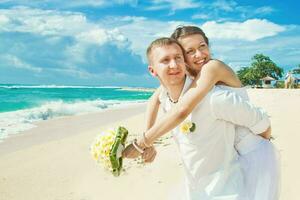 Newly married couple on the beach photo