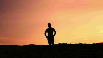 Slow motion. Men practice trail running in the evening. Silhouette of man running video