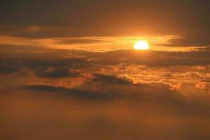 Sunset back horizon sky with orange cloud and fog over on the top mountain photo