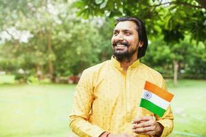 indian man holding indian flag photo