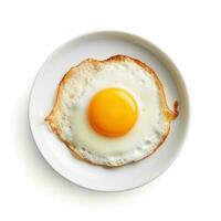 Fried egg on white plate isolated photo