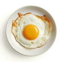 Fried egg on white plate isolated photo
