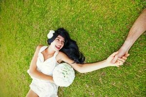 Woman laying on the grass photo