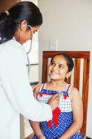 Indian doctor treating a little Indian girl photo