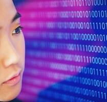 a woman looking at a computer screen with binary code photo