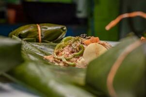 Closeup of raw ingredients for the elaboration of a Nicaraguan nacatamal. Nacatamal ingredients on banana leaves, Preparation of the traditional Nacatamal photo