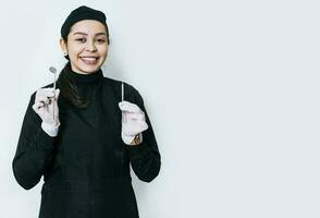 Portrait of a dentist with dental tools, portrait of a female dentist with mirror and dental probe, isolated dentist woman with dental tools photo